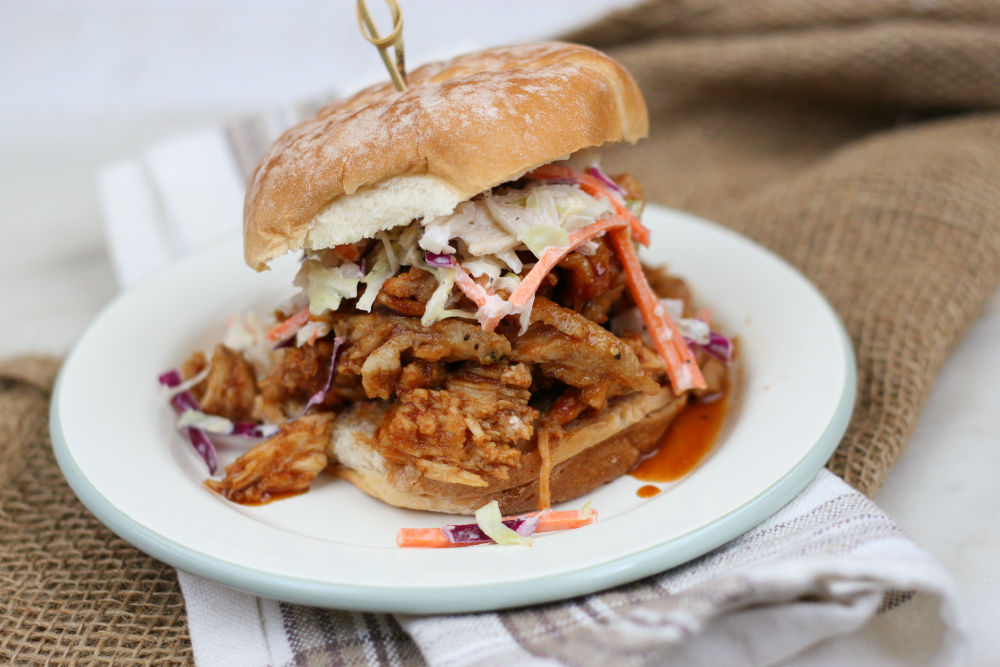 pulled pork on a soft roll topped with coleslaw