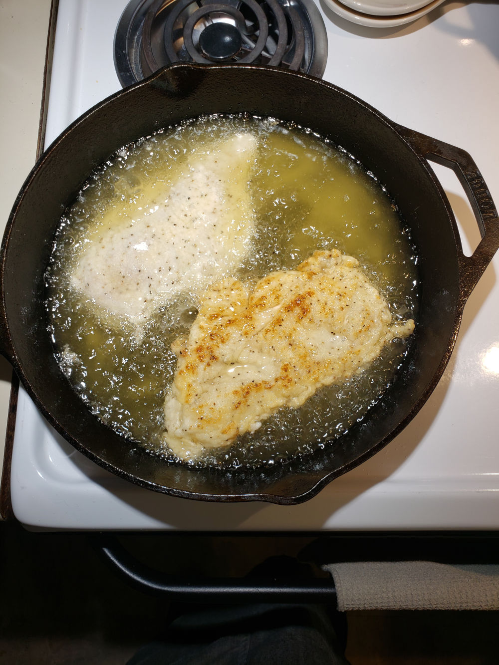 frying buttermilk chicken in a cast iron skillet.