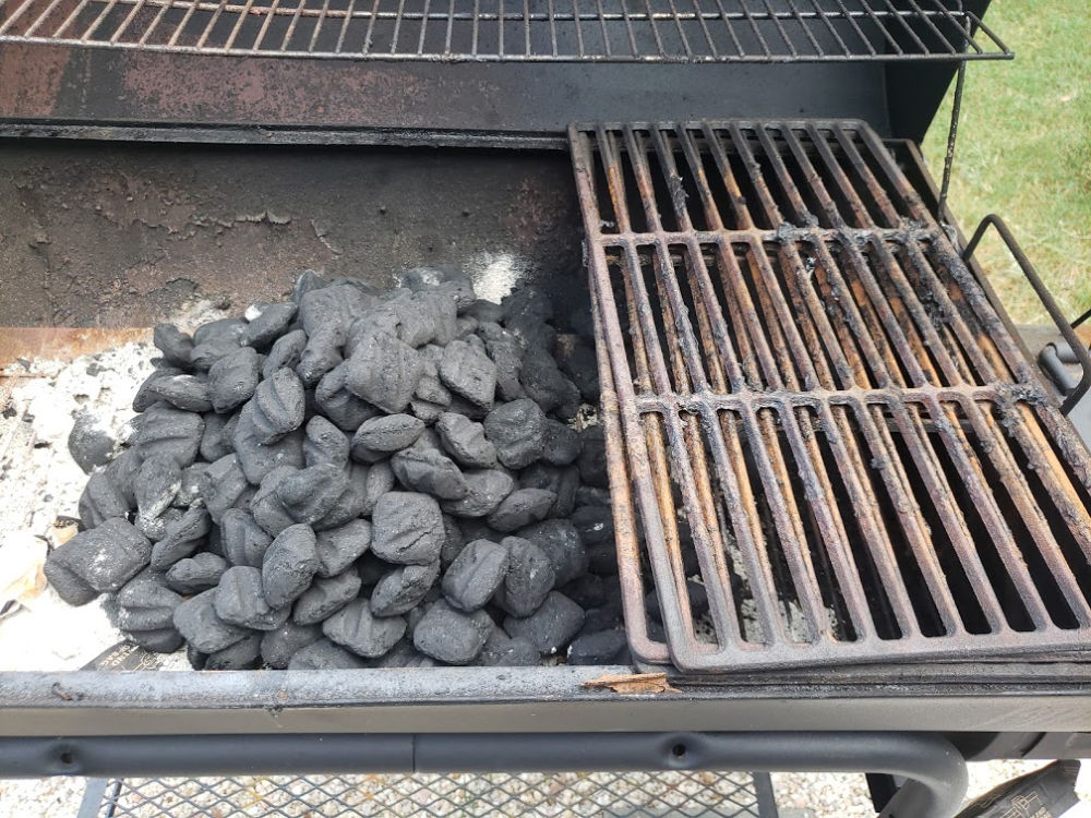 prepping a charcoal grill to light the charcoal briquets