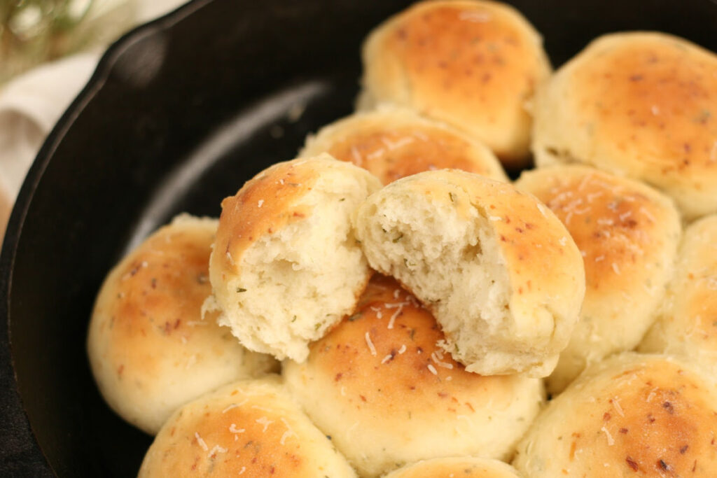 dinner rolls with rosemary and Parmesan cheese in cast iron skillet