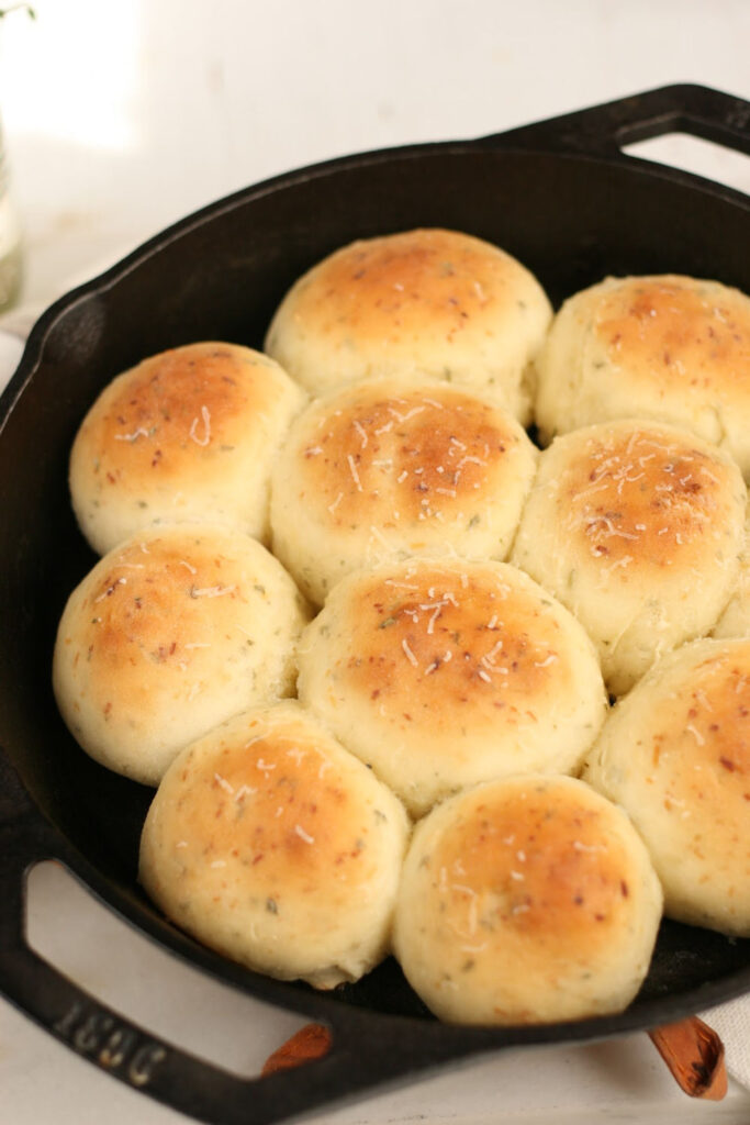 homemade dinner rolls in two-handled cast iron pan