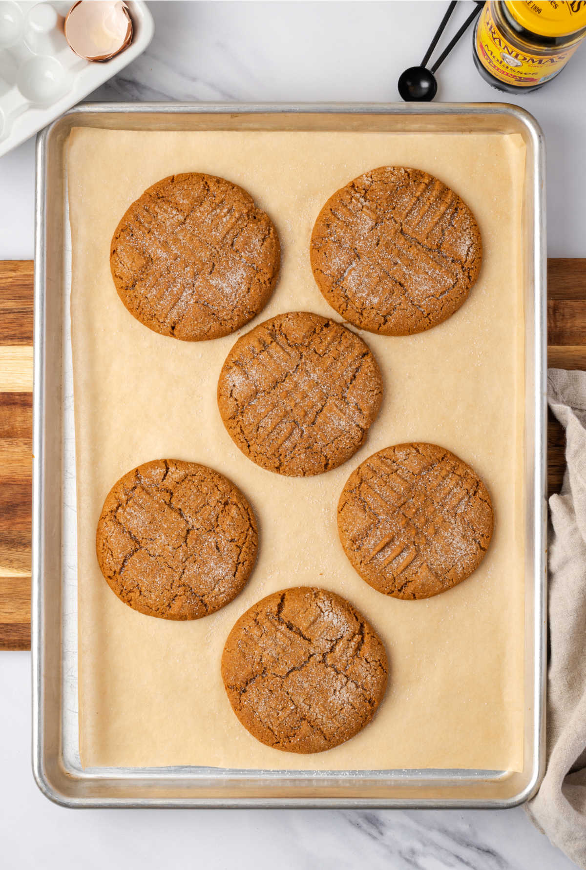Molasses cookies on half sheet pan.