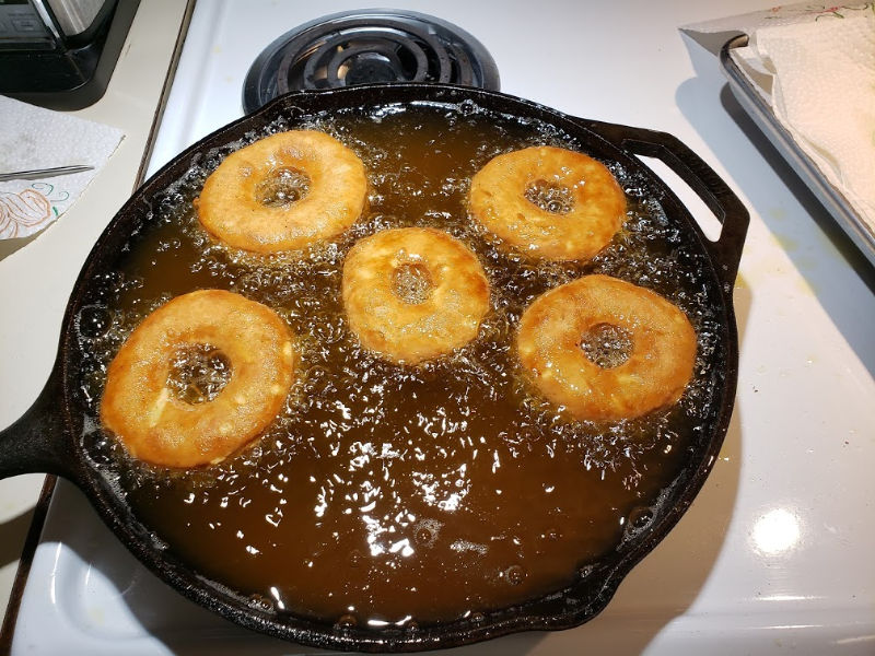 frying doughnuts in a cast iron skillet