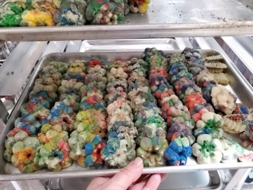 Colorful Spritz Cookies on half sheet pan. On baking rack