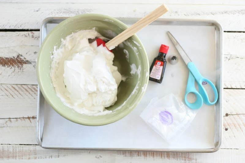 Bowl of whipped meringues, adding food coloring and peppermint flavoring
