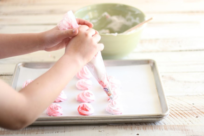 Pastry bag to squeeze meringues on sheet pan