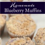 blueberry muffins with crumb topping on white marble