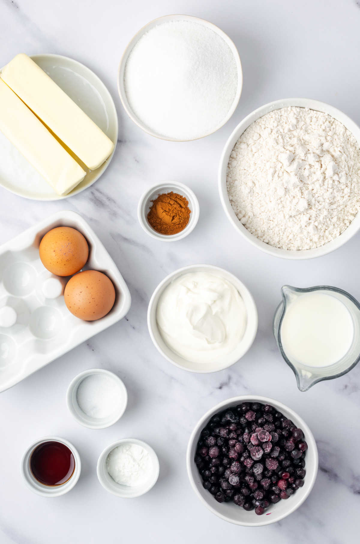 Ingredients for muffins in small white bowls.