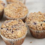Blueberry muffins with crumb topping on white marble