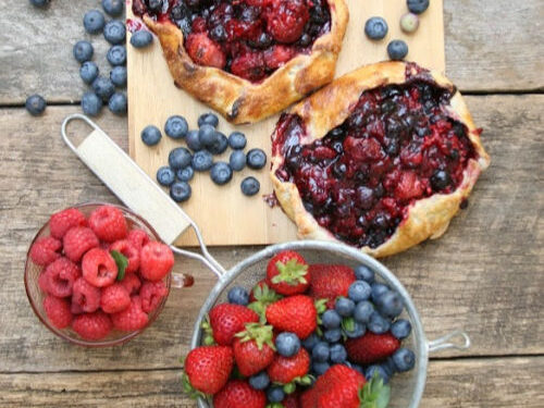 berry galettes on reclaimed wood with mixed berries