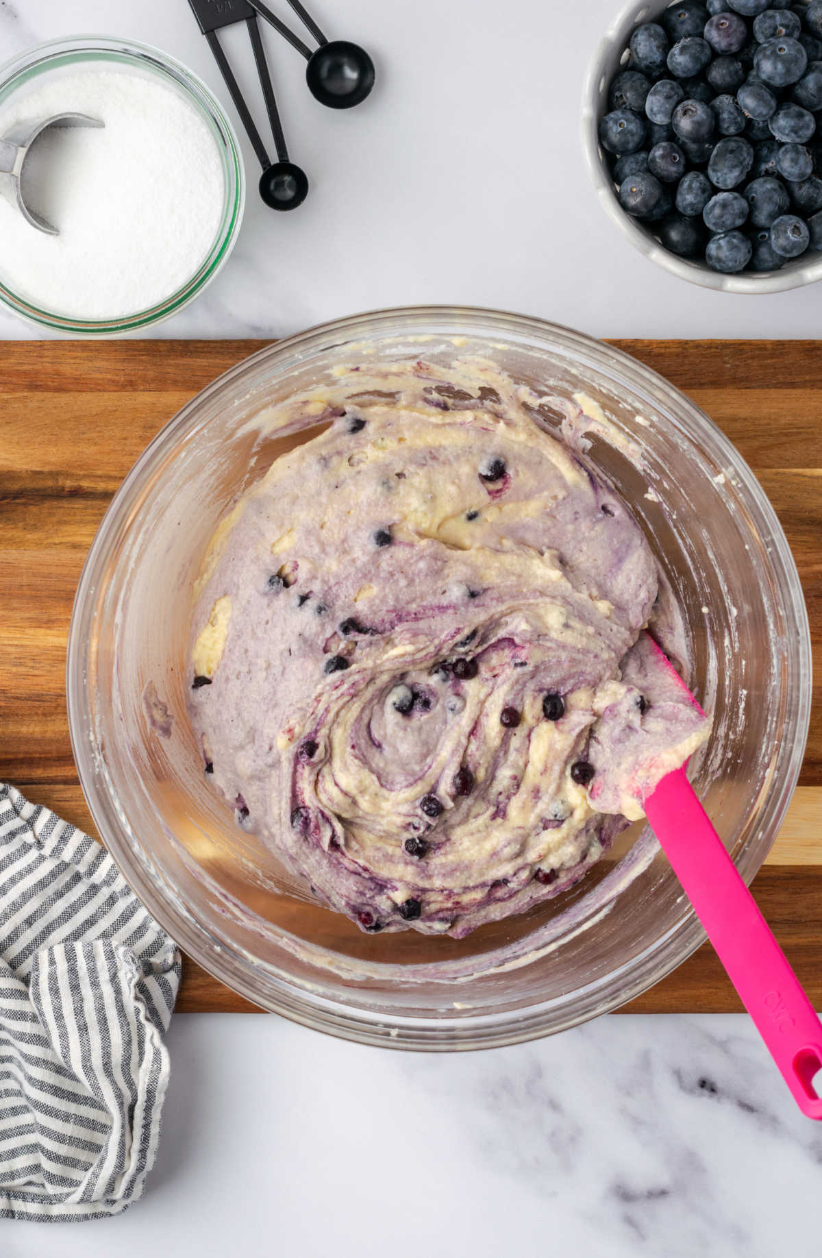Muffin batter in clear glass bowl.