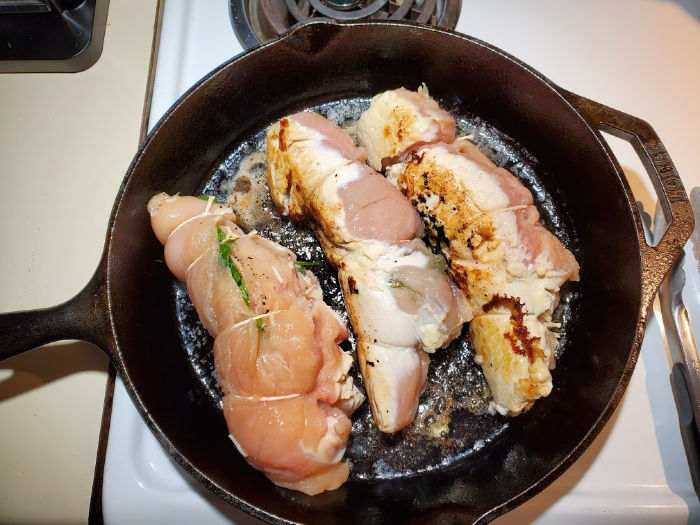 browning stuffed chicken breasts in cast iron skillet