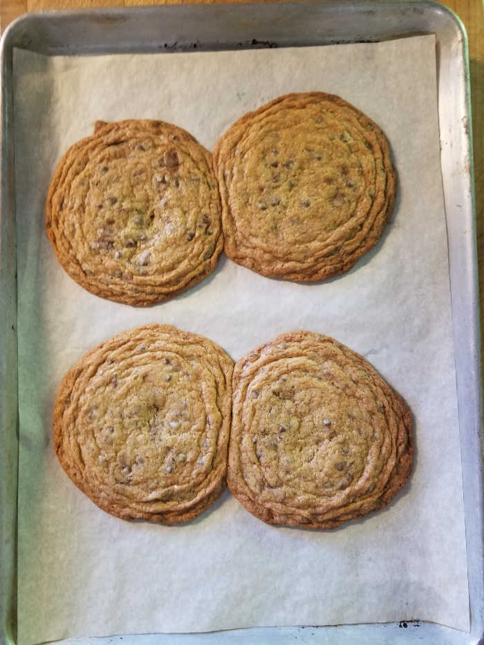 chocolate chip cookies on baking pan lined with white parchment paper