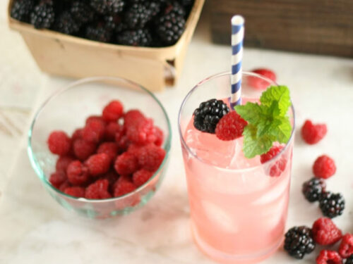 glass of raspberry lemonade with fresh fruit