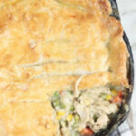 chicken pot pie in a dual handle cast iron skillet.