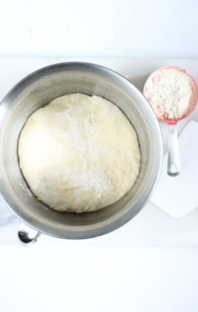 metal mixing bowl with bread dough