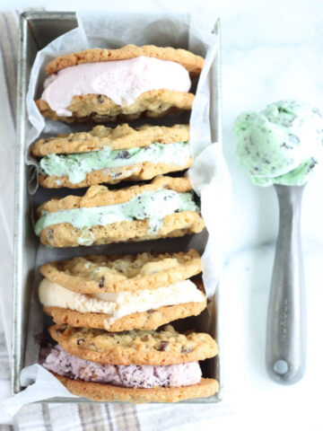 chocolate chip ice cream sandwiches with different kinds of ice cream stacked against each other in metal loaf pan