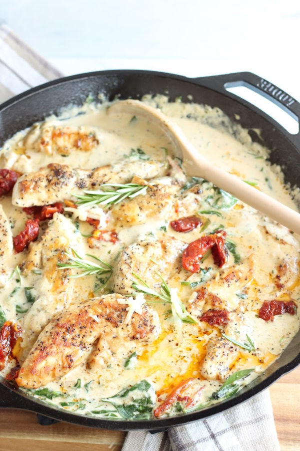 chicken breasts in cream sauce, sun dried tomatoes, spinach, in cast iron skillet