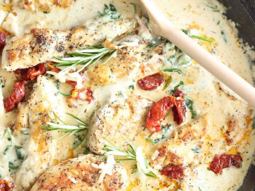 cast iron skillet with cream sauce, chicken, sun dried tomatoes, spinach, topped with fresh rosemary