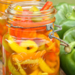 pickled peppers in vintage Mason jars on reclaimed wood boards