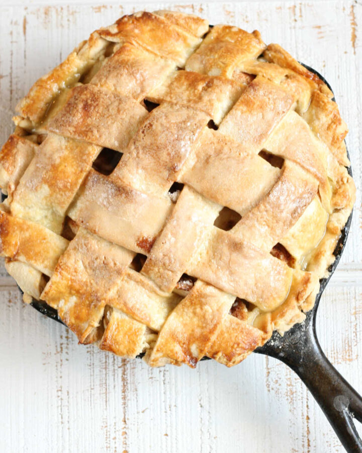Apple pie with lattice crust in cast iron skillet.
