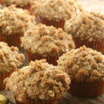 Banana muffins with oatmeal topping on reclaimed wood boards.
