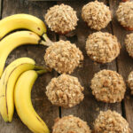 Muffins on reclaimed wood boards, bananas to left.