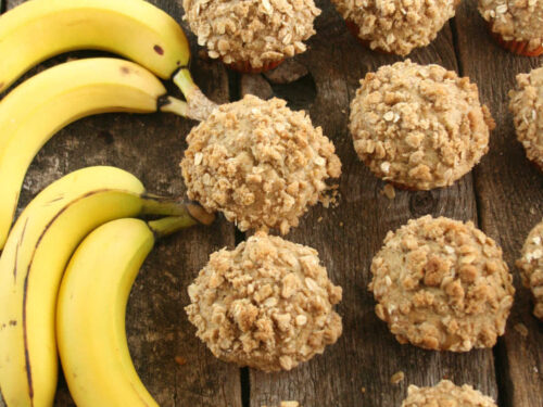 Muffins on reclaimed wood boards, bananas to left.