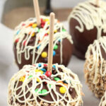 chocolate caramel apples on wooden serving tray