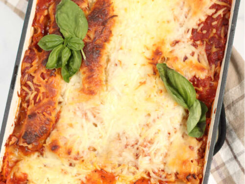 lasagna in a turquoise color cast iron baking dish