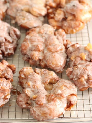 apple fritters on baking rack with glaze drying.