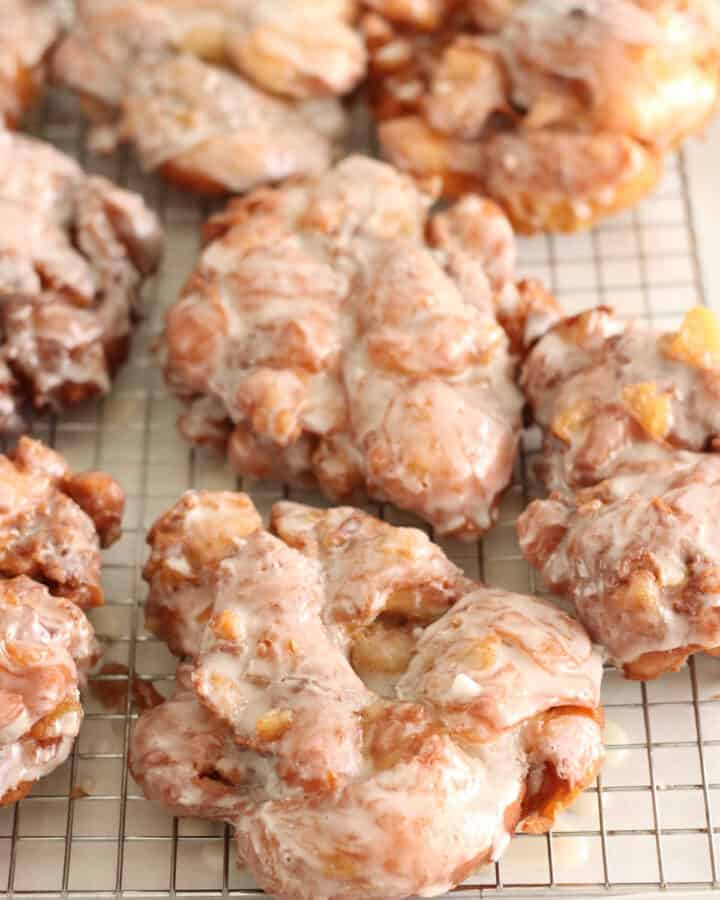 apple fritters on baking rack with glaze drying.