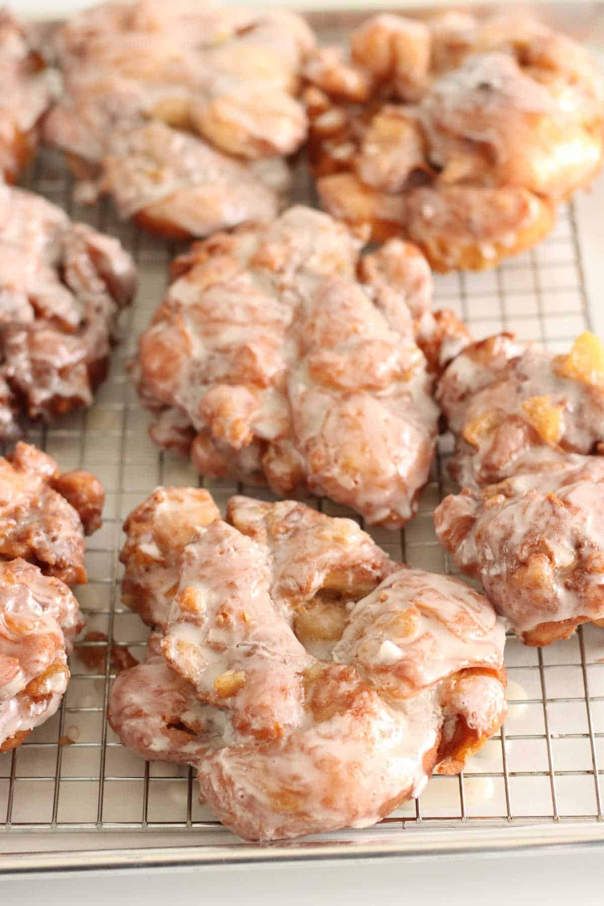 apple fritters on baking rack with glaze drying.