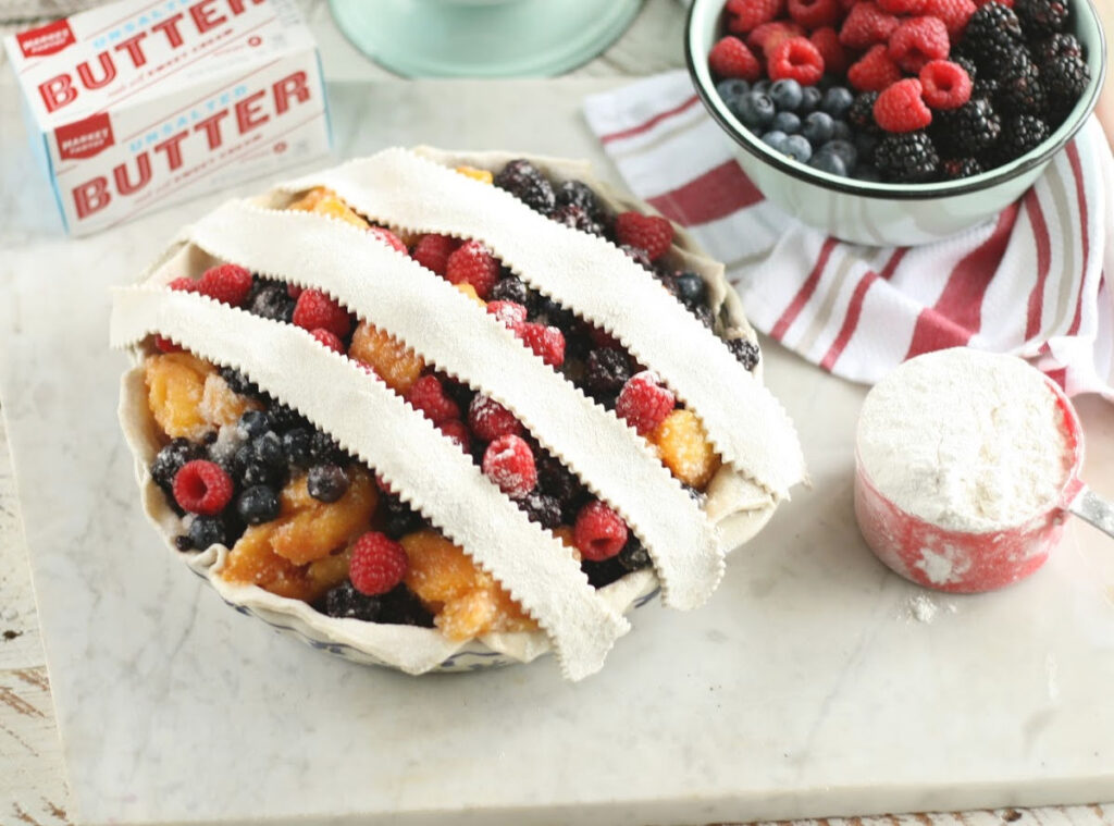 making a lattice crust on mixed berry pie.