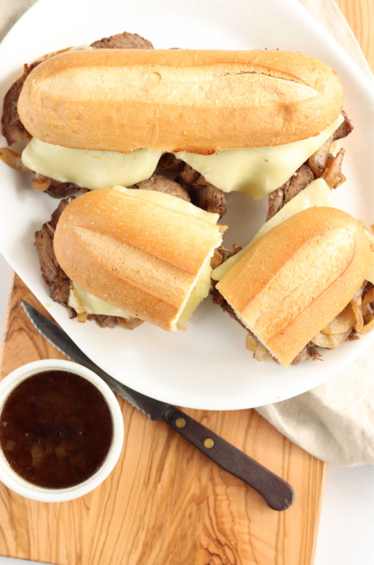 Easy to make French dip is made with chuck roast, onion soup mix, simple spices and slow cooked.