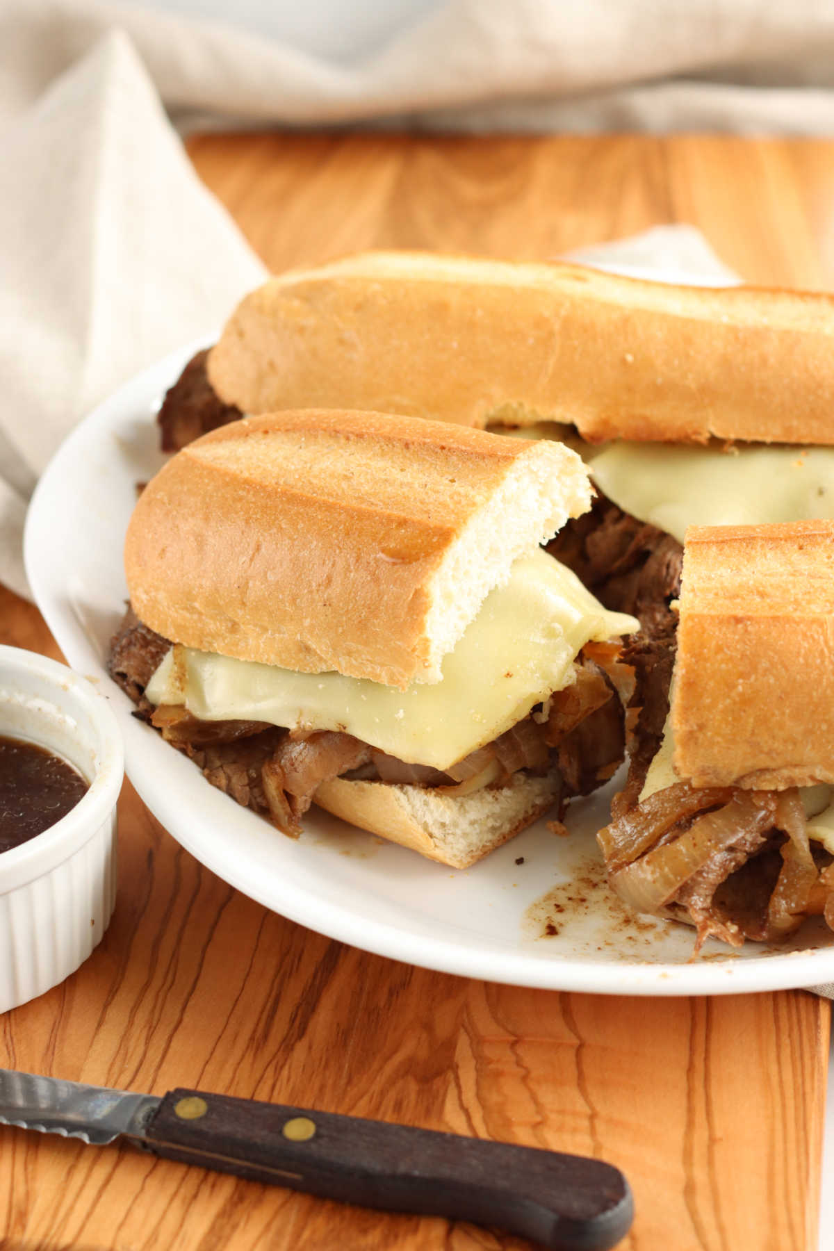 French dip is made with a chuck roast, onion soup mix, apple cider, and simple spices slow cooked.
