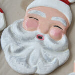 Santa salt dough ornament drying on brown Kraft paper.