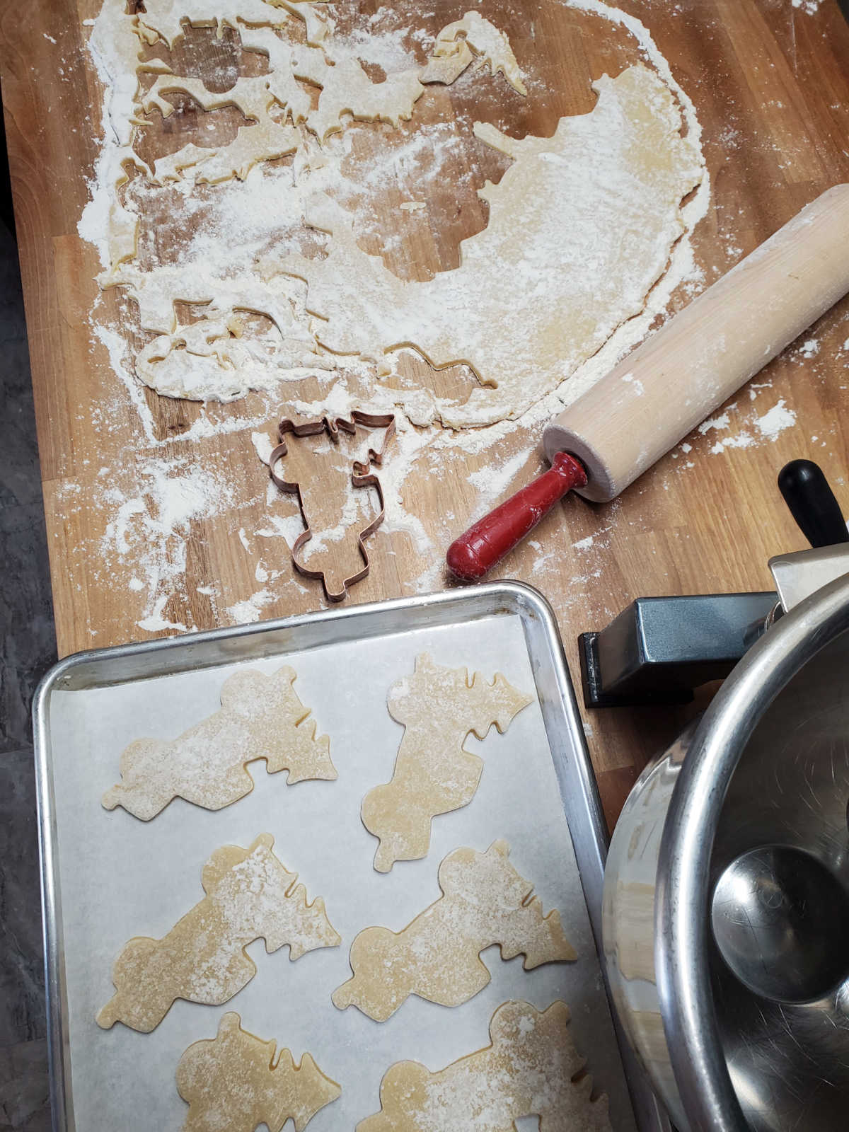 Christmas cookies of vintage trucks cut out on butcher block.