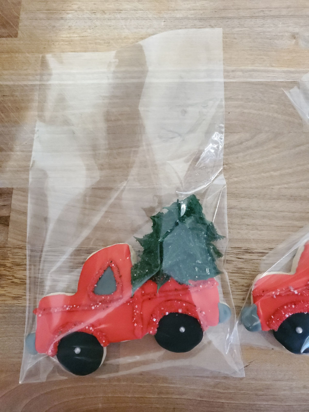 Red truck with Christmas trees in plastic bags.