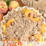 Peach pie with crumb topping unbaked on butcher block.
