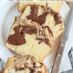 Slices of marble cake on small white plate.