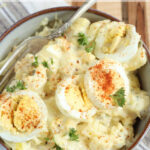 Bowl with potato salad with hard boiled eggs.