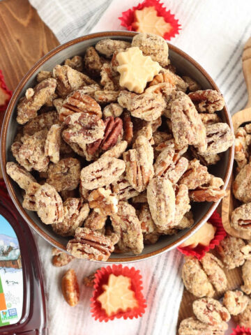 Candied pecans in small bowl, maple candies around.
