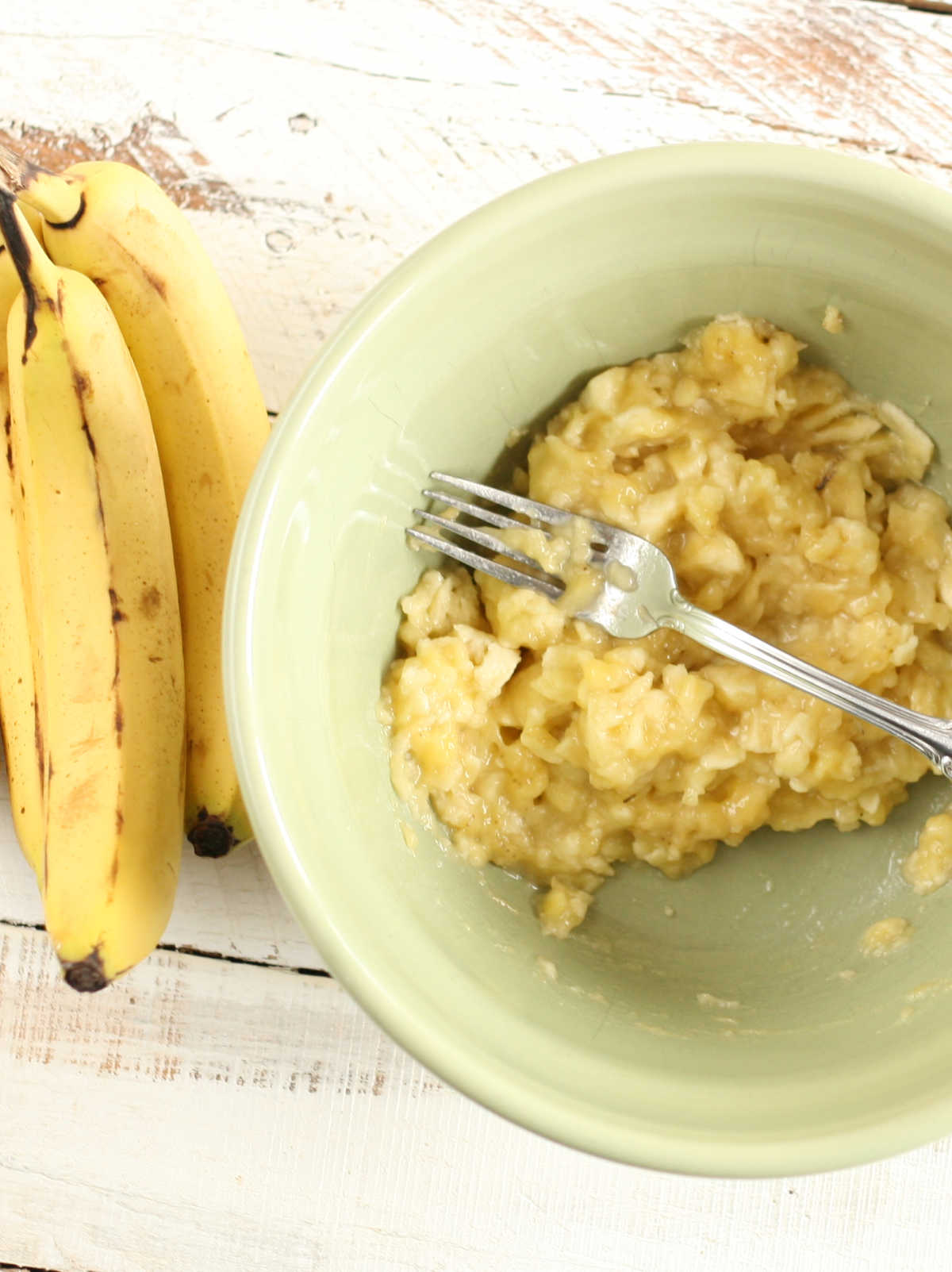 Mashed bananas in small bowl.