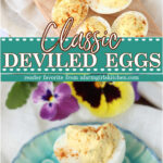 Deviled eggs with paprika on wooden cutting board.