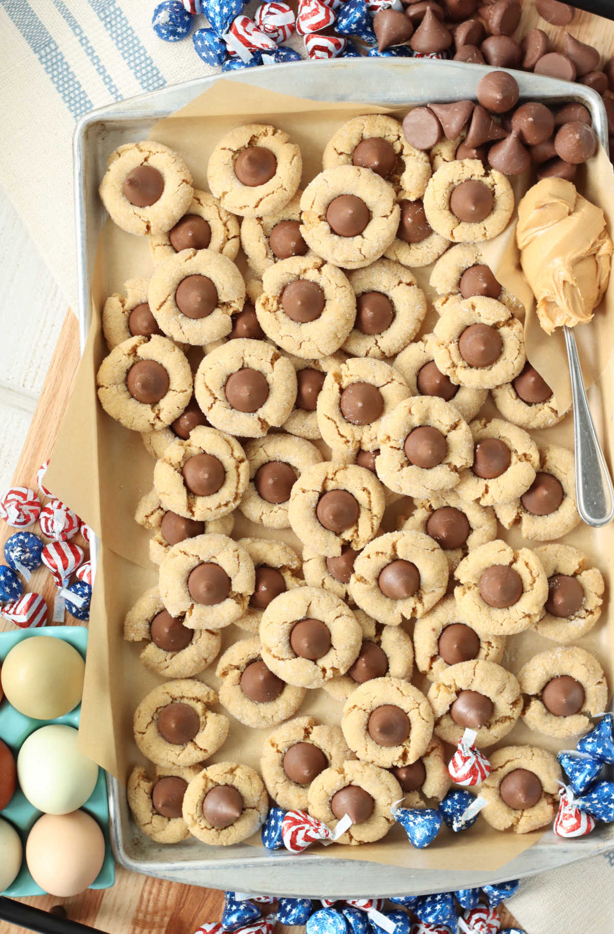 Peanut butter blossom cookies on sheet pan.