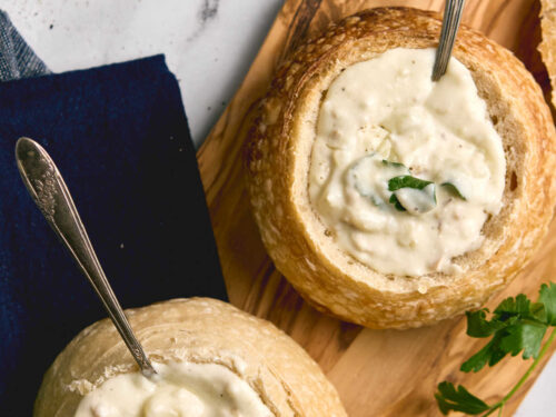 Closeup of clam chowder in bread bowl.