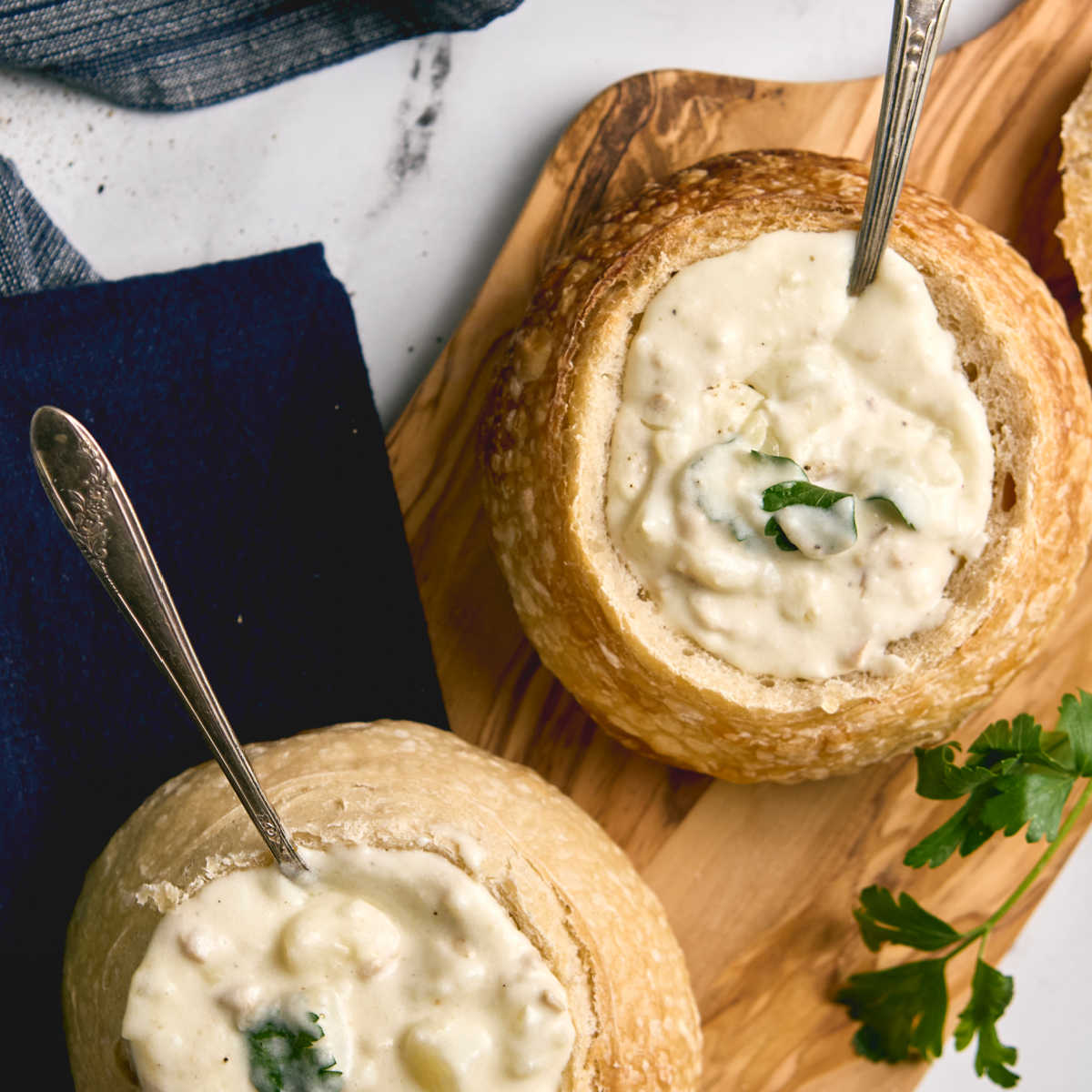 Closeup of clam chowder in bread bowl.