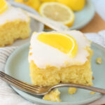 Square of lemon cake on small plate with Boston fruit slice on top.