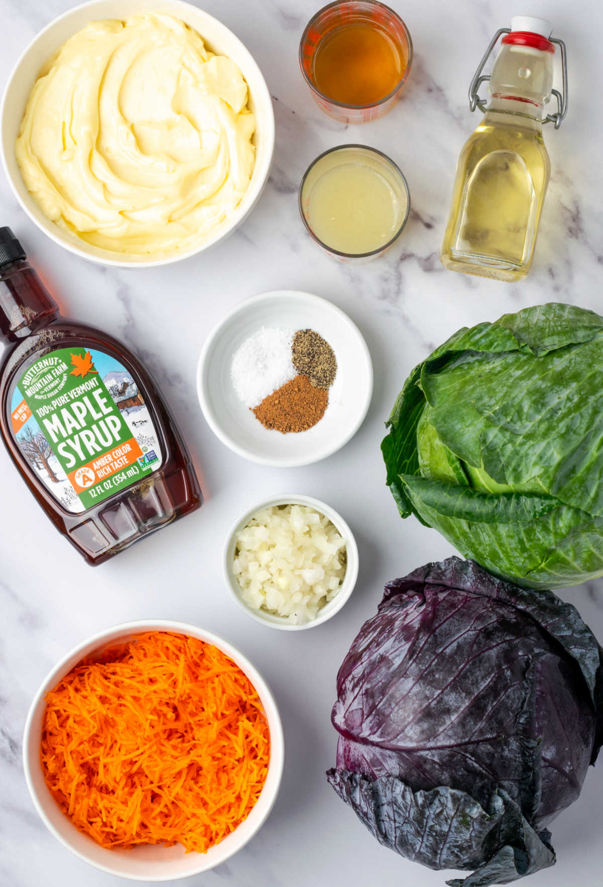 Ingredients for coleslaw on white marble counter.
